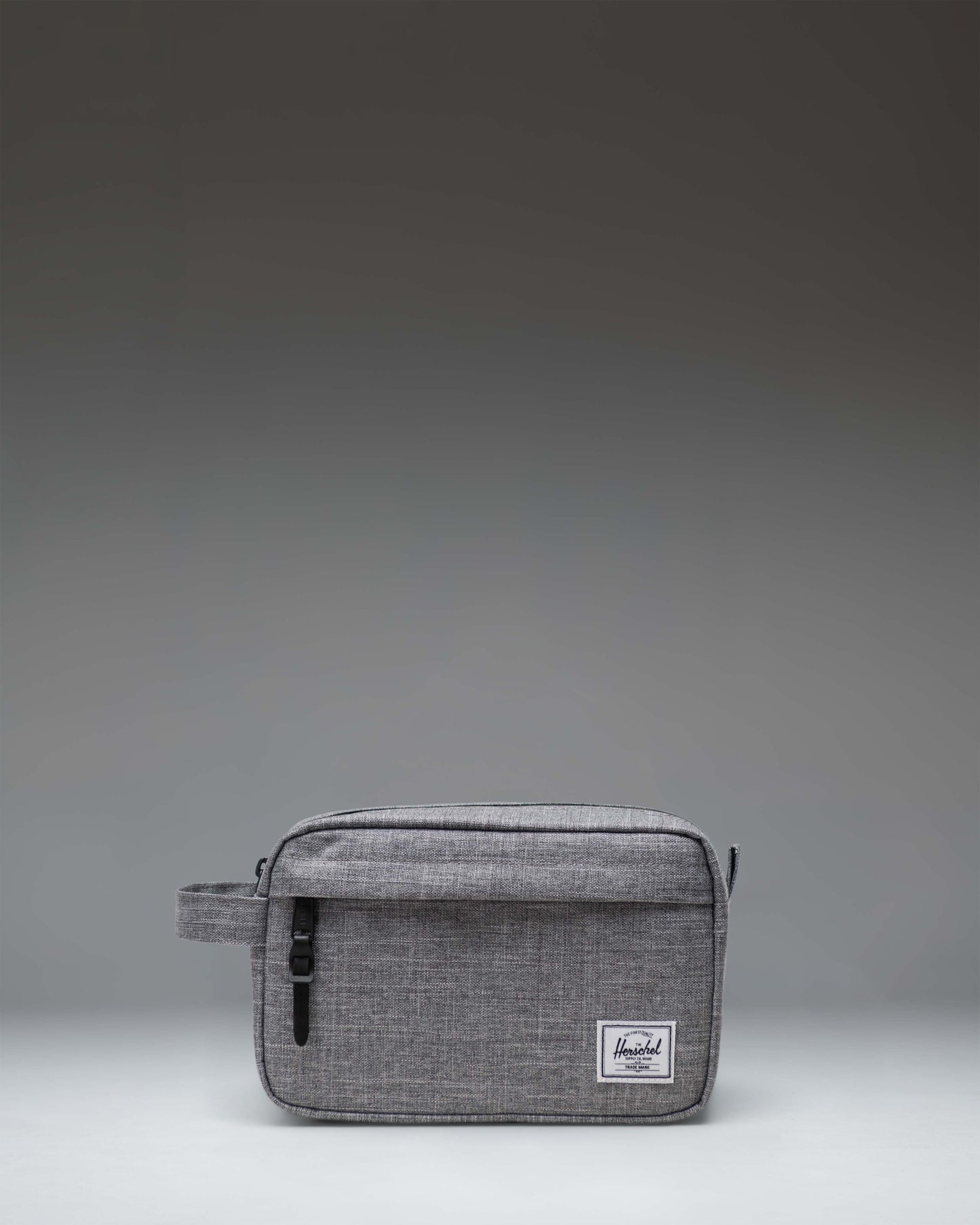 Herschel Supply Co. Chapter Travel Kit in Raven Crosshatch grey, featuring a front zippered pocket and a convenient side carrying handle.