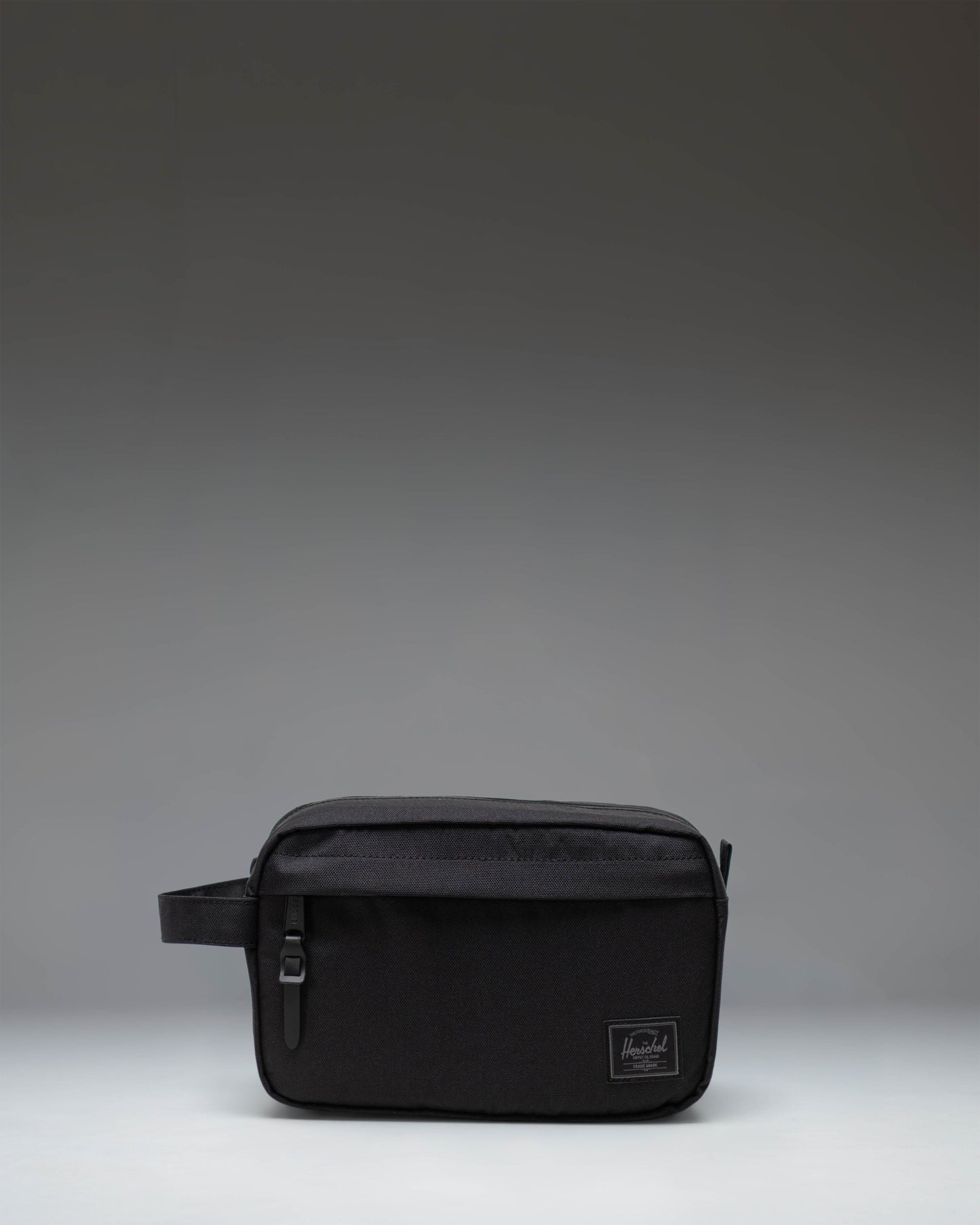 Herschel Supply Co. Chapter Travel Kit in Black Tonal, showing the side profile view with the classic carrying handle.