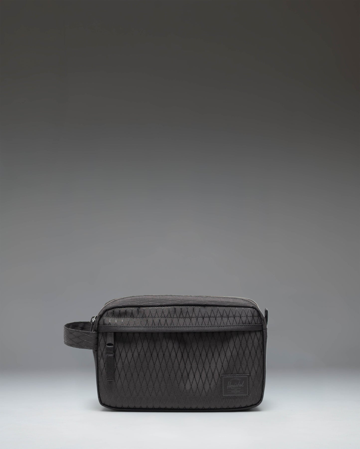 Herschel Supply Co. Chapter Travel Kit in Black Diamond/Black showing a front view of the structured toiletry bag with a carrying handle.