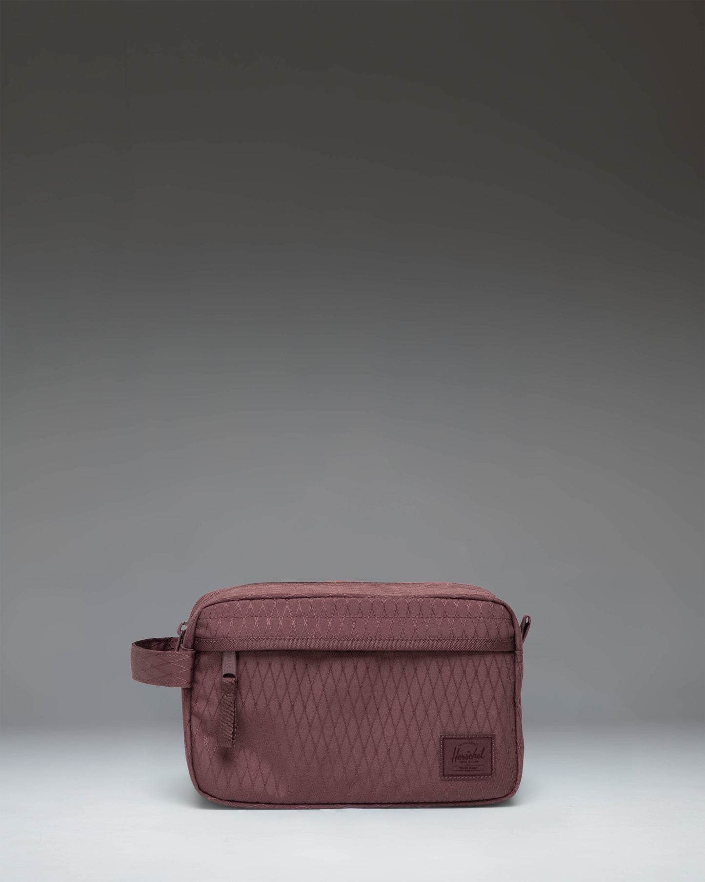 Herschel Supply Co. Chapter Travel Kit toiletry bag featuring the Huckleberry Diamond geometric pattern with a side handle and front pocket.