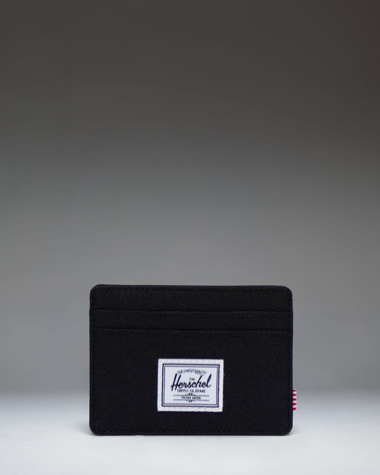 Herschel Supply Co. Charlie Cardholder wallet in solid black featuring multiple card slots and the signature woven label.