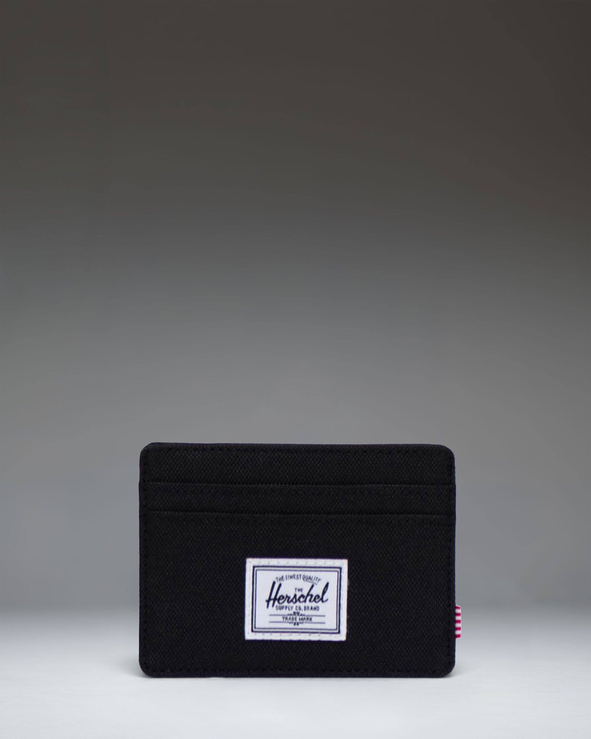 Herschel Supply Co. Charlie Cardholder wallet in solid black featuring multiple card slots and the signature woven label.
