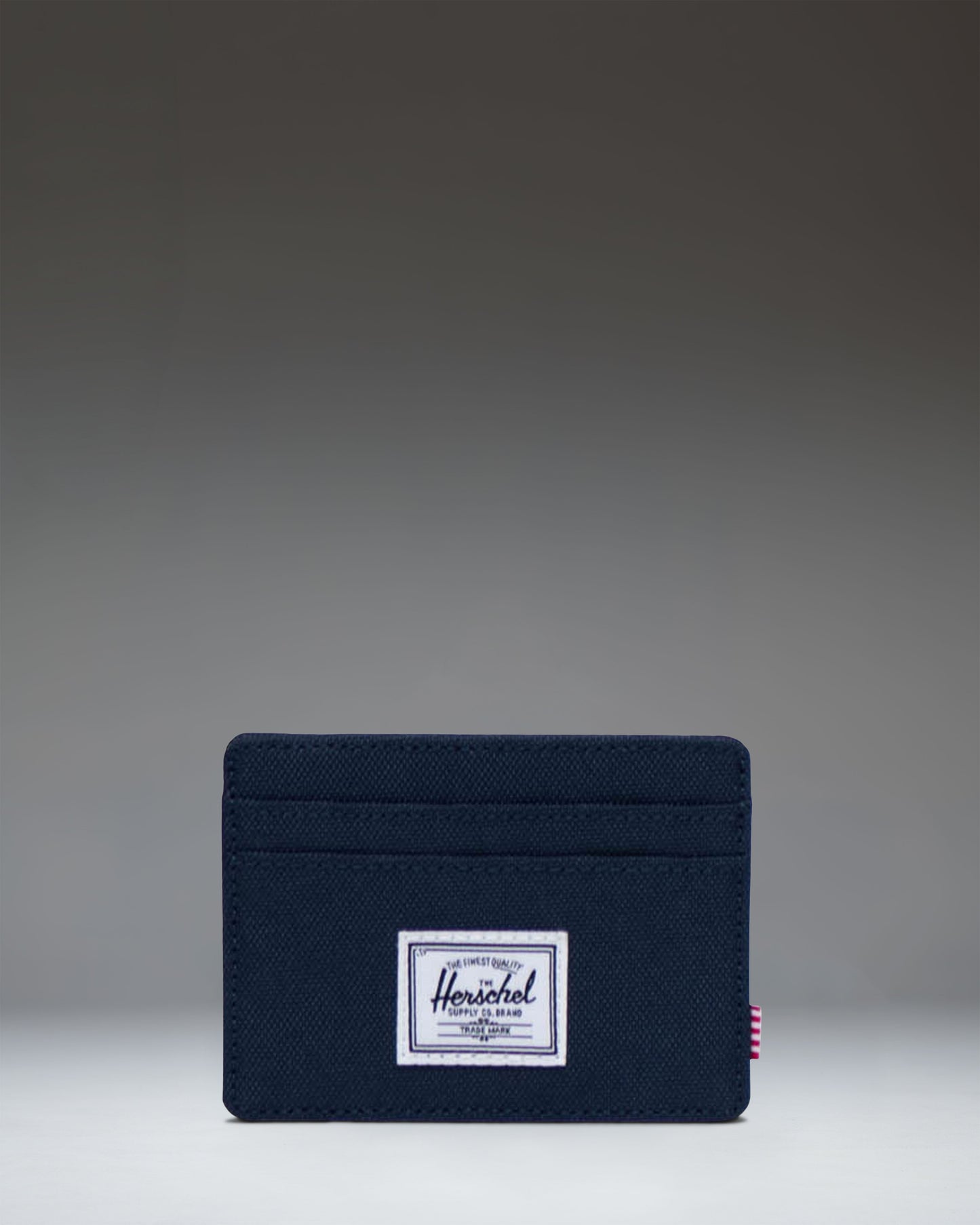 Herschel Supply Co. Charlie Cardholder in Navy, showing a minimalist slim wallet design with multiple card slots.