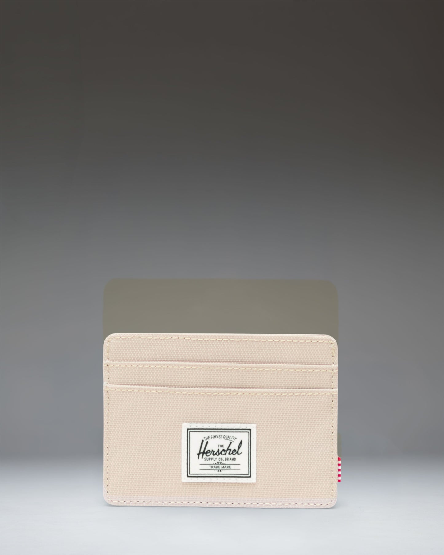 Herschel Supply Co. Charlie Cardholder in Eucalyptus green. Front view of the slim wallet showing multiple card slots and signature woven label.