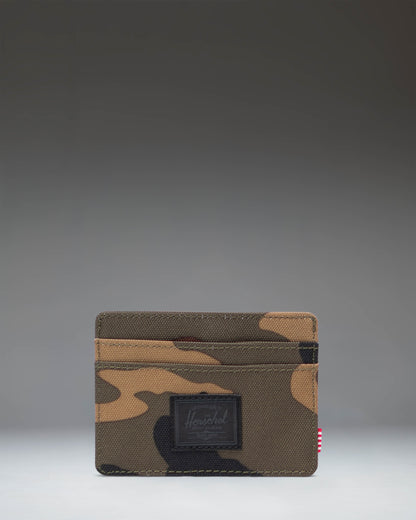 Herschel Supply Co. Charlie Cardholder in Woodland Camo with a black label, showing the slim wallet design.