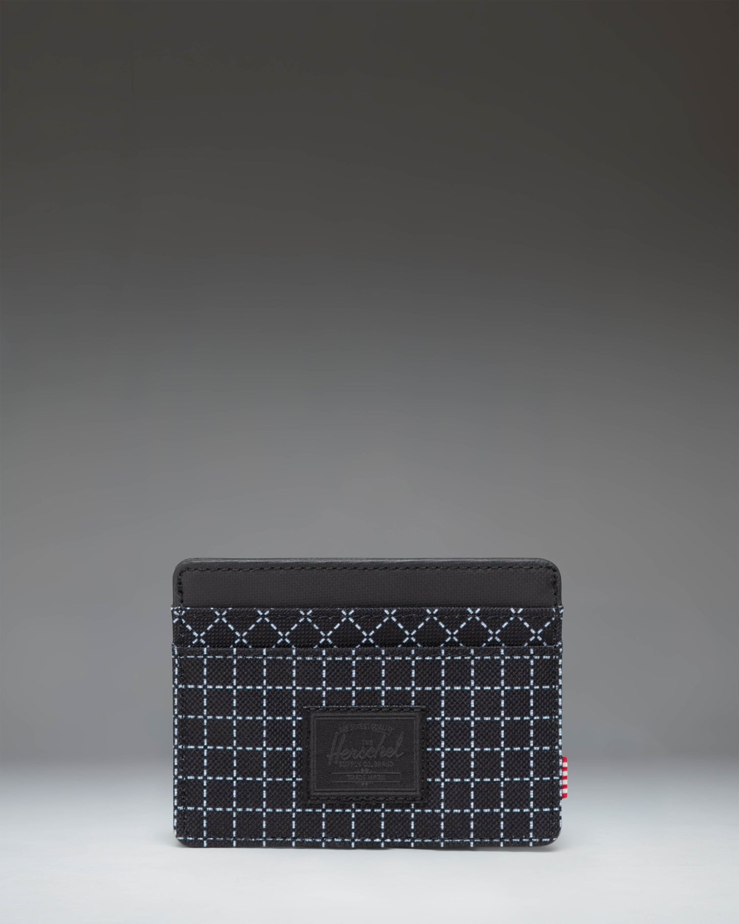 Herschel Supply Co. Charlie Cardholder in Grid Black/Black, showing the sleek, compact design with multiple card slots and a textured grid pattern.