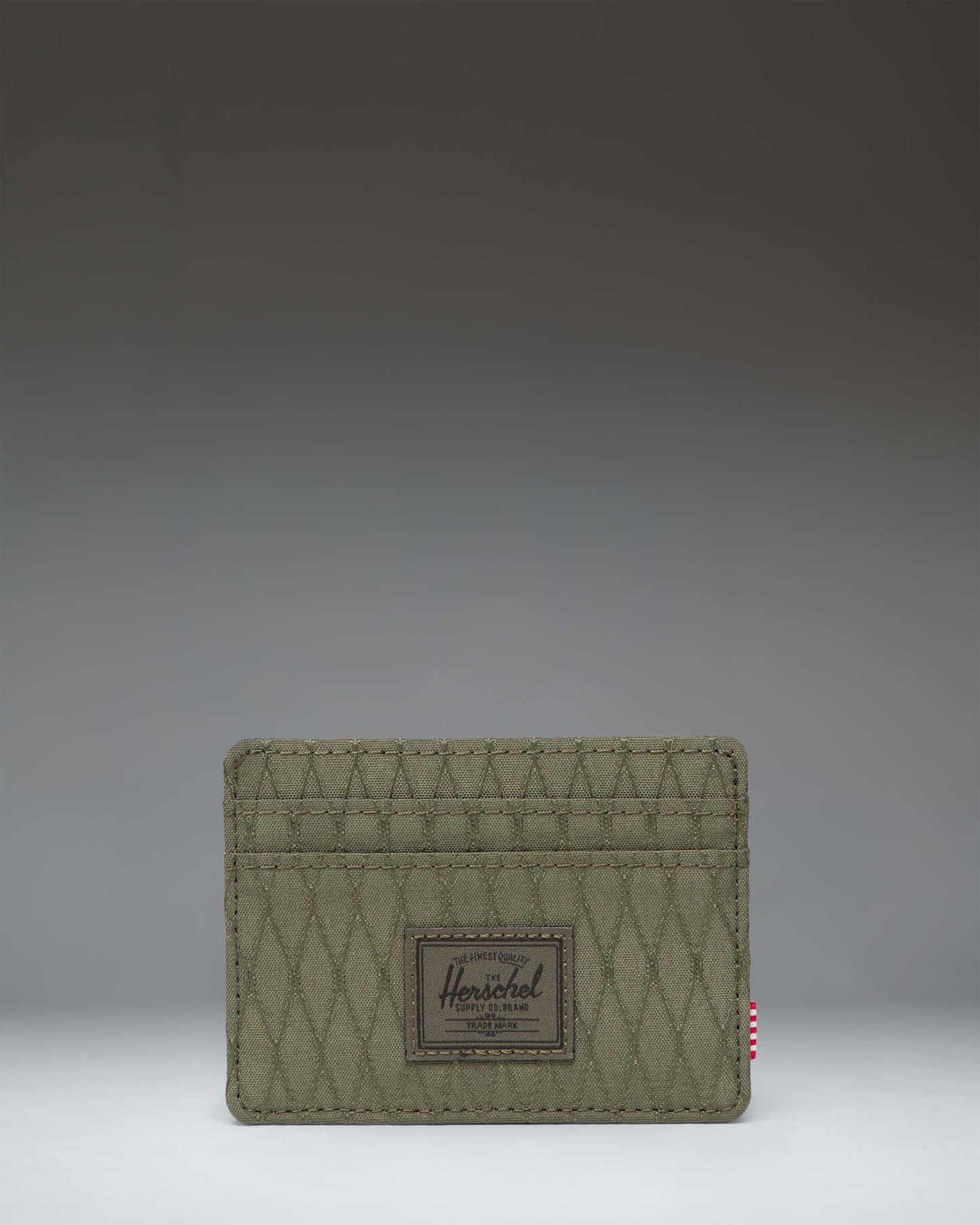 Herschel Supply Co. Charlie Cardholder in Ivy Green Diamond, featuring a compact design with multiple card slots and a textured diamond pattern.