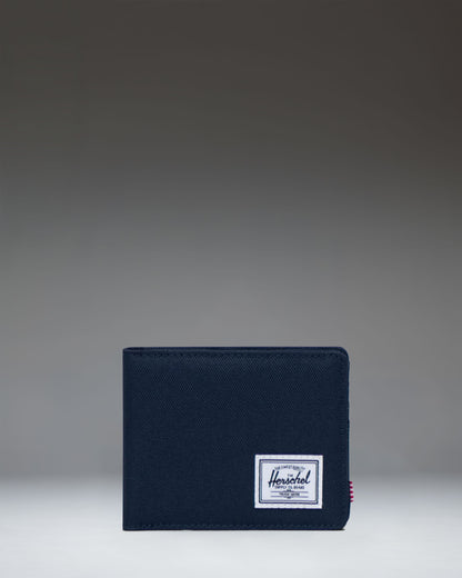 Herschel Supply Co. Roy Wallet in Navy, showing a close-up of the classic bi-fold design and durable fabric.