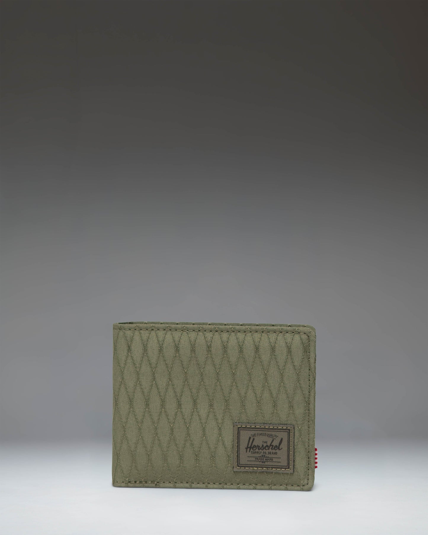 Herschel Supply Co. Roy Wallet in Ivy Green Diamond, showing a classic bi-fold design with a textured diamond pattern fabric.