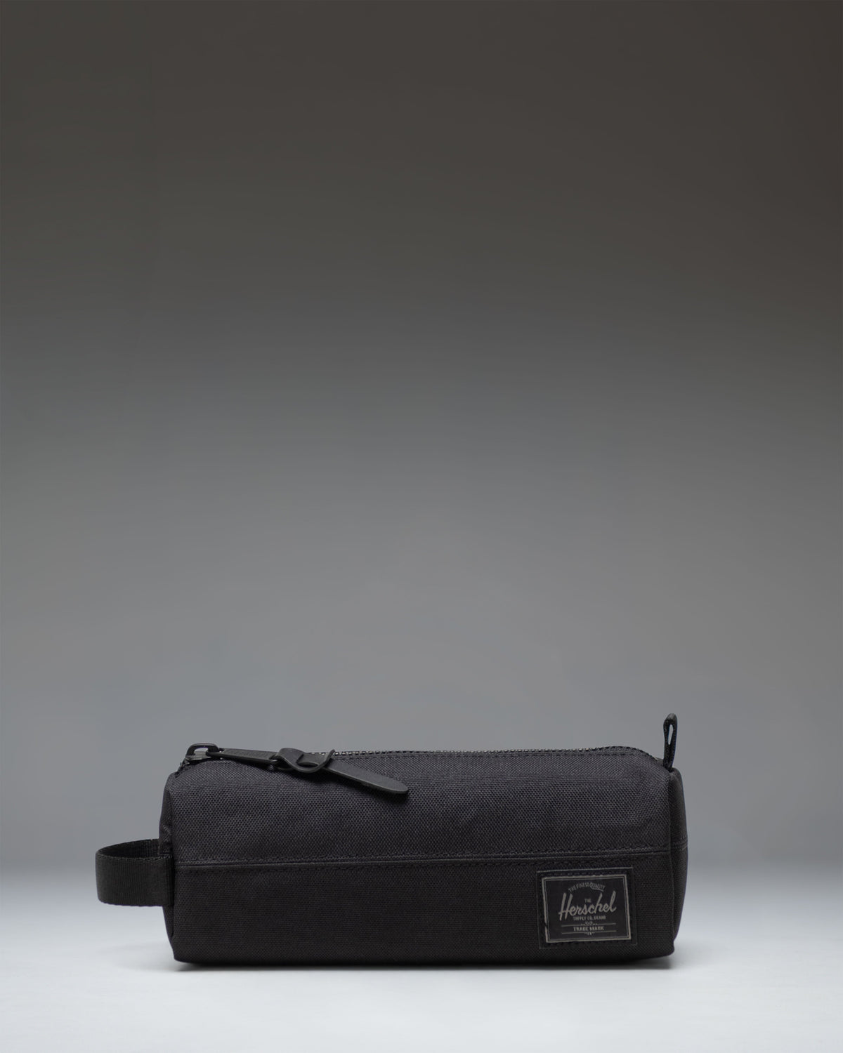Herschel Supply Co. Settlement Pencil Case in Black Tonal, showing the classic zippered pouch design with a clean, monochromatic finish.