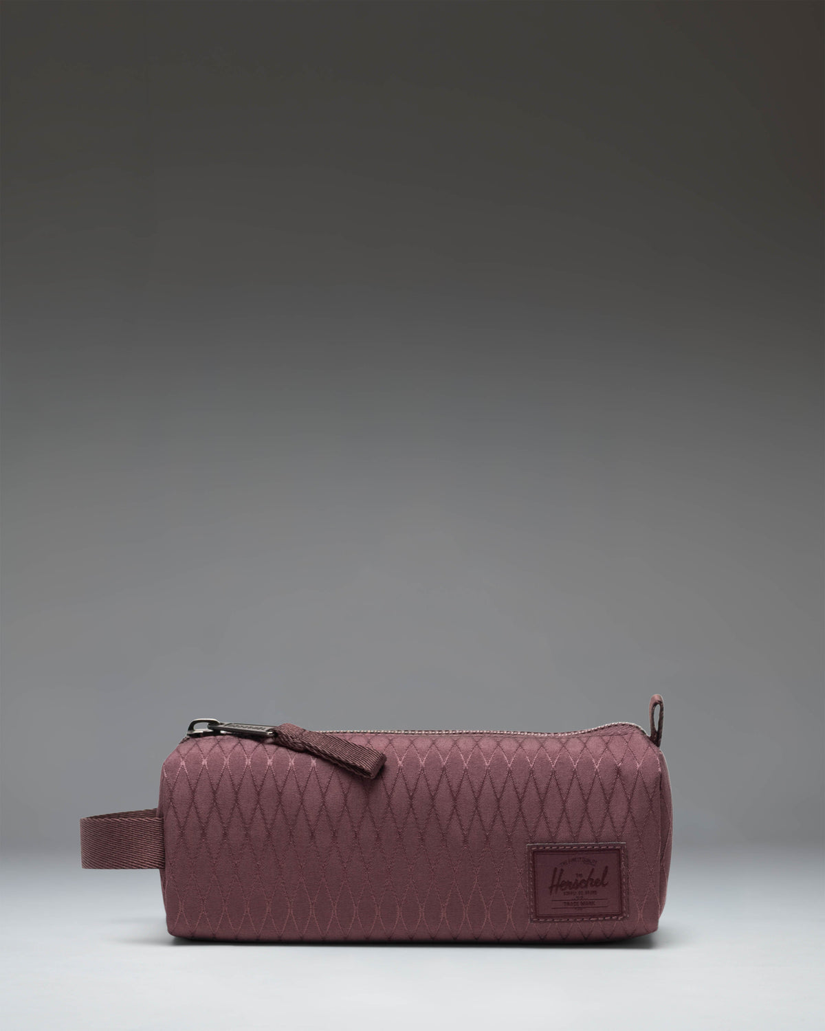 Herschel Supply Co. Settlement Pencil Case in Huckleberry Diamond, featuring a purple diamond geometric pattern with a zippered closure.