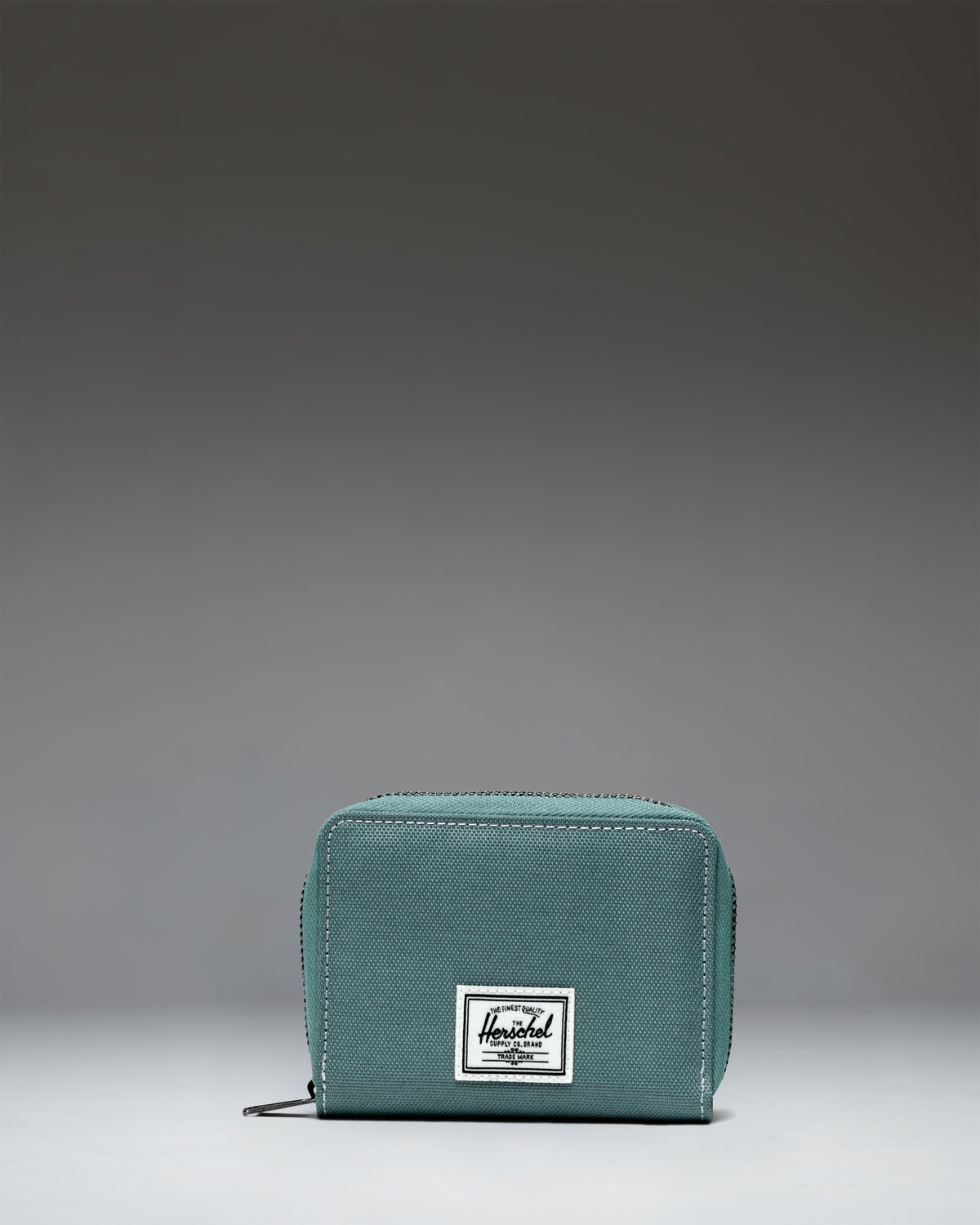 Herschel Supply Co. Tyler Wallet, a compact bifold zip wallet featuring card slots and a center divider.