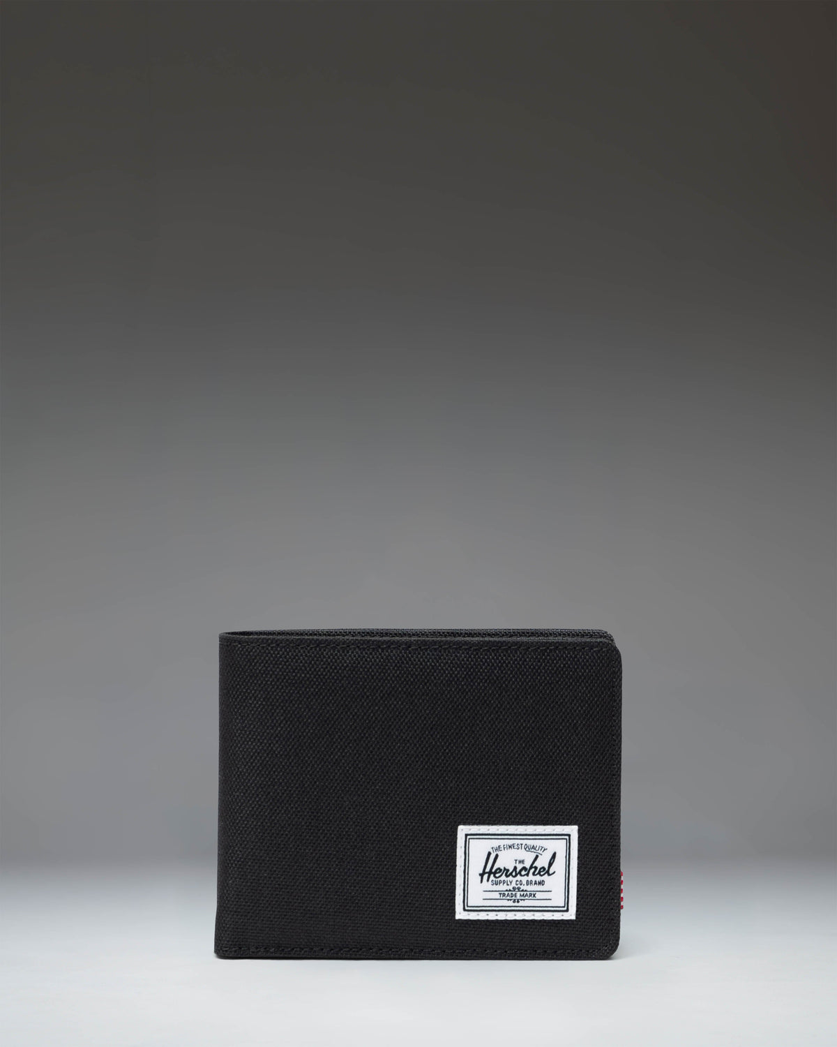 Black Herschel Supply Co. Roy Coin Wallet bi-fold design showing the clean front exterior with the classic woven label.