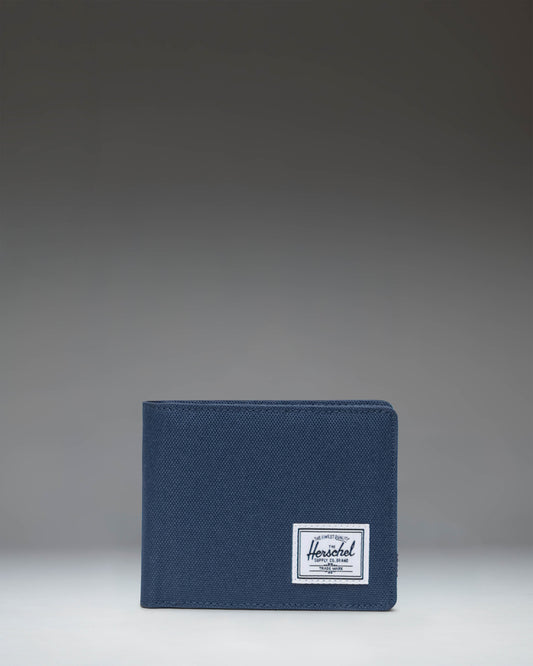 Herschel Supply Co. Roy Coin Wallet in navy blue, showing an open view with card slots and a coin pocket.