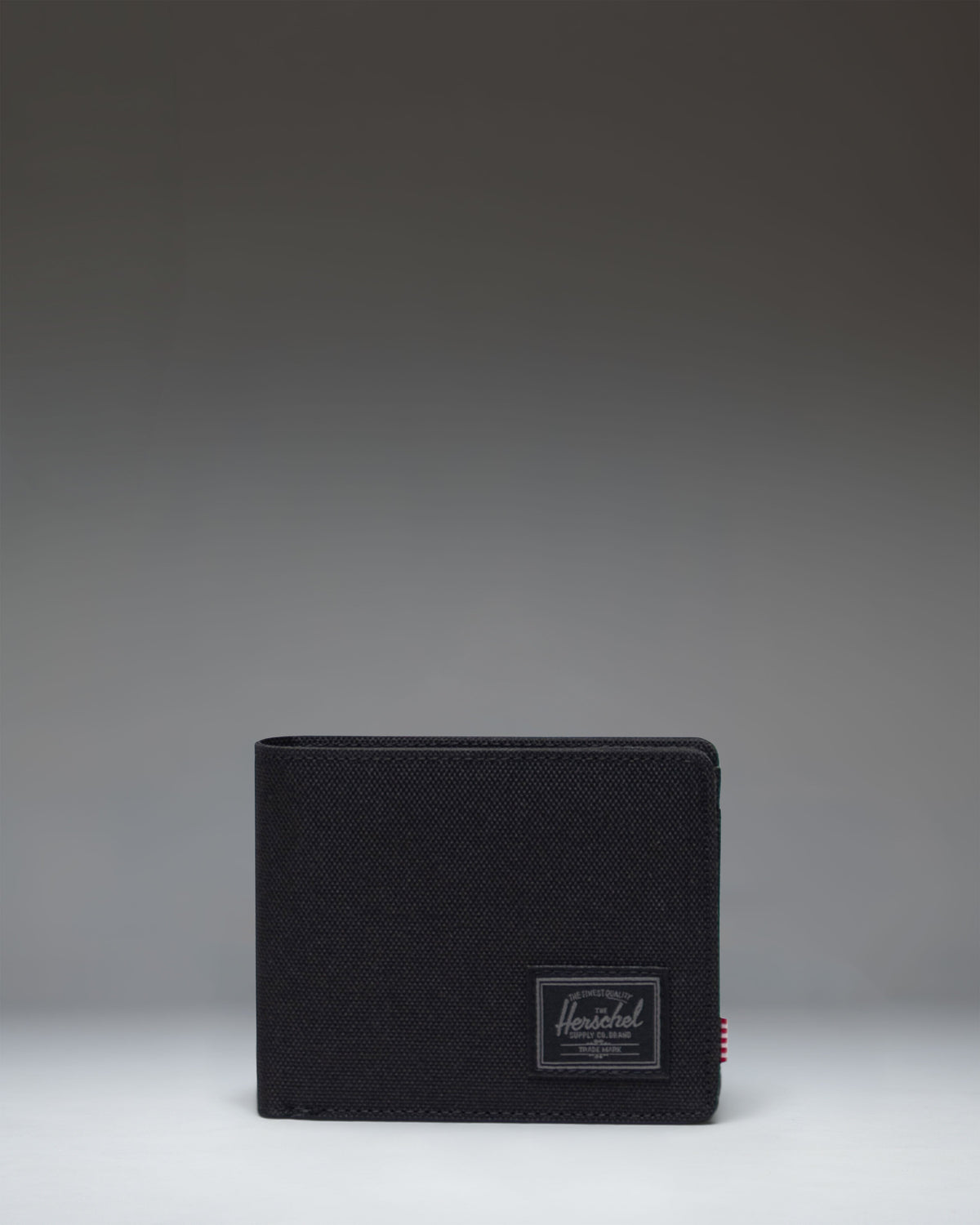 Herschel Supply Co. Roy Coin Wallet in Black Tonal, a classic bi-fold wallet featuring a clean, minimalist design with a tonal logo patch.