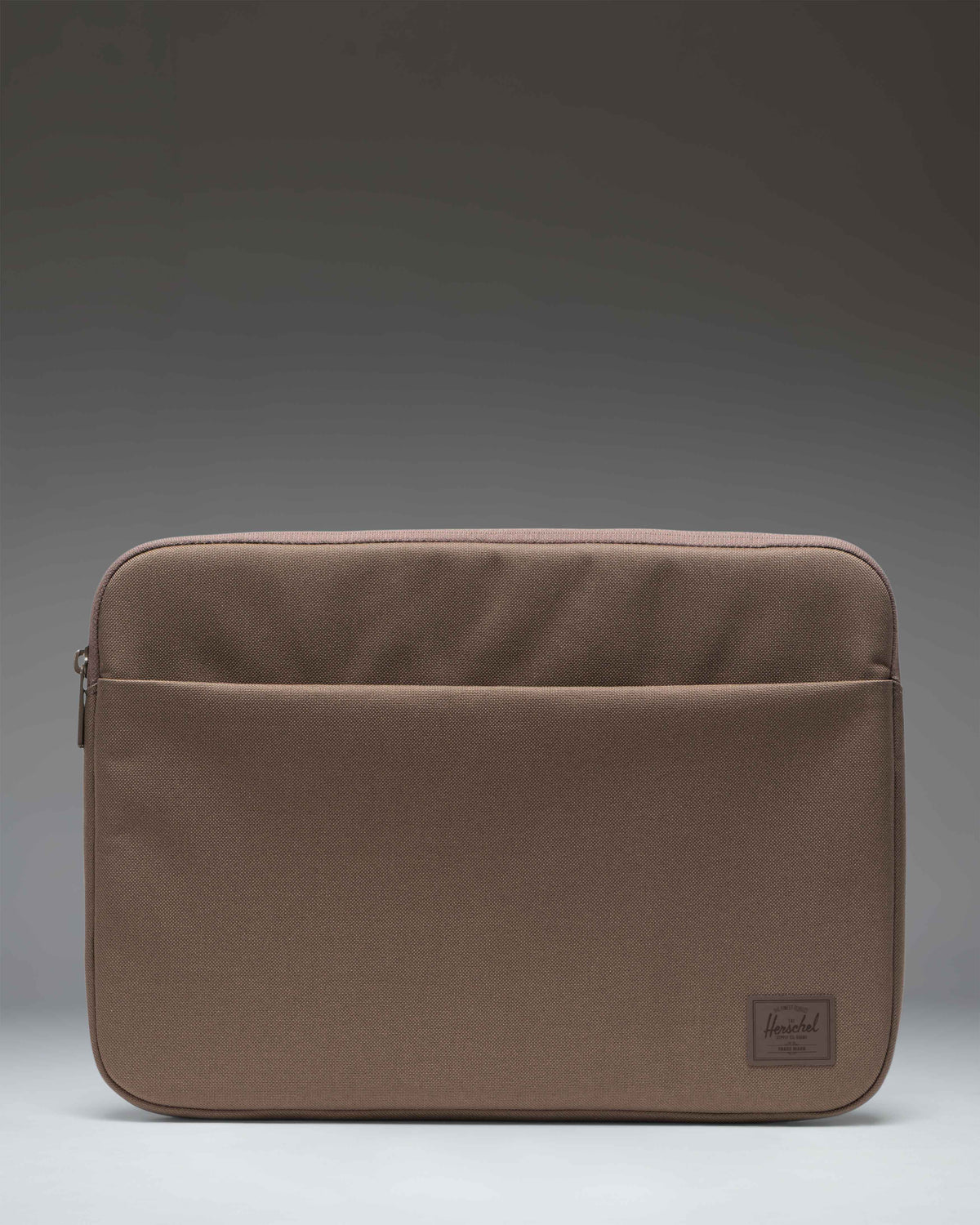 Herschel Supply Co. Denman 14 Inch Sleeve Tech in Light Brown, a padded laptop sleeve with a minimalist design and a secure zipper closure.