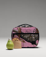 Herschel Supply Co. Realtree Pop Quiz Lunch Box in Realtree Edge Camo Pink/Black featuring a durable, insulated main compartment.