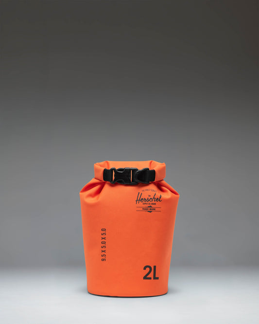 Herschel Supply Co. Dry Bag Organizer 2L in Vermillion Orange, showing a bright orange waterproof pouch with a roll-top closure.