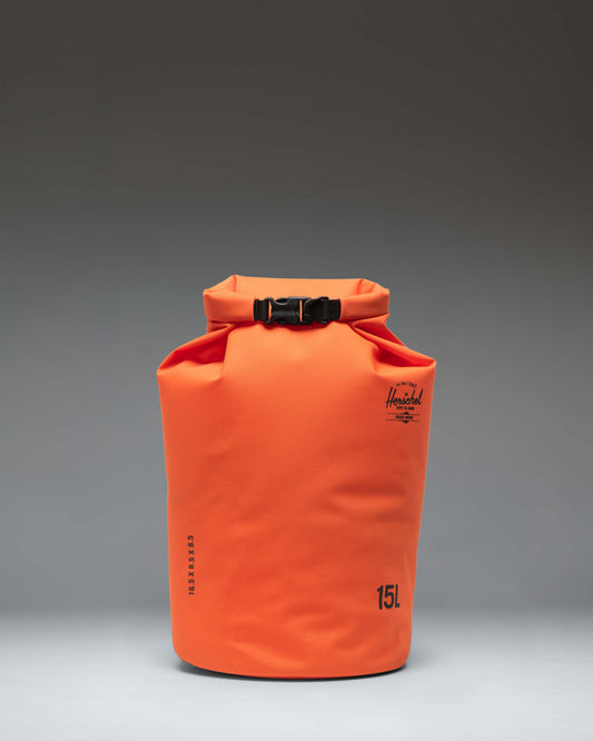 Herschel Supply Co. Dry Bag Organizer 15L in Vermillion Orange, showing a front view of the bright orange roll-top waterproof bag.