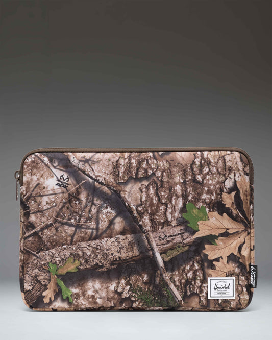 Herschel Supply Co. Anchor 14 Inch Sleeve in Realtree APX Camo pattern.