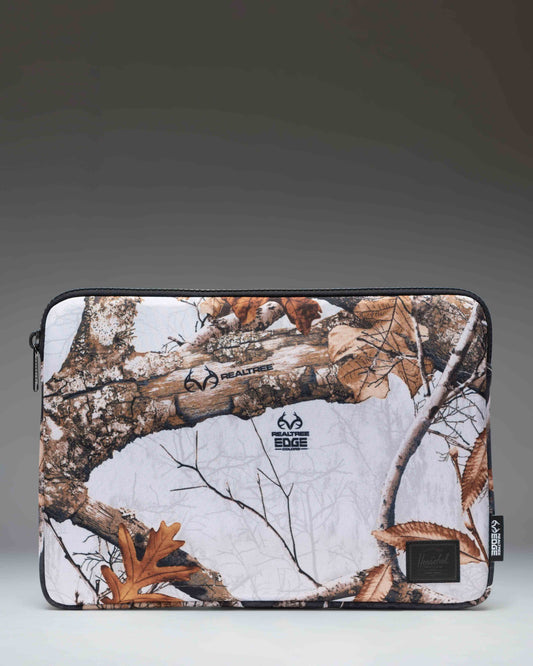 Herschel Supply Co. Realtree Anchor 14 Inch Sleeve in Realtree Edge Camo White/Black, a padded laptop sleeve with a woodland camouflage pattern.