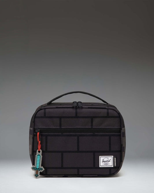 Herschel Supply Co. Minecraft Pop Quiz Lunch Box in The Nether colorway featuring a black insulated interior and pixelated orange graphic pattern.