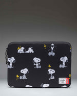 Herschel Supply Co. Peanuts Anchor 14 Inch Sleeve in Snoopy and Woodstock Black, featuring a repeating print of Snoopy and Woodstock.