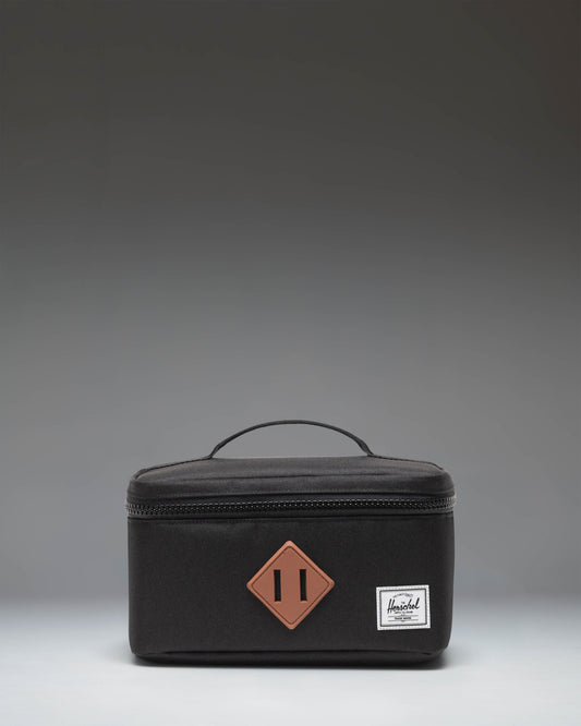 Herschel Heritage Lunch Box Little Herschel in black, featuring a classic rectangular design with a top handle and front storage sleeve.