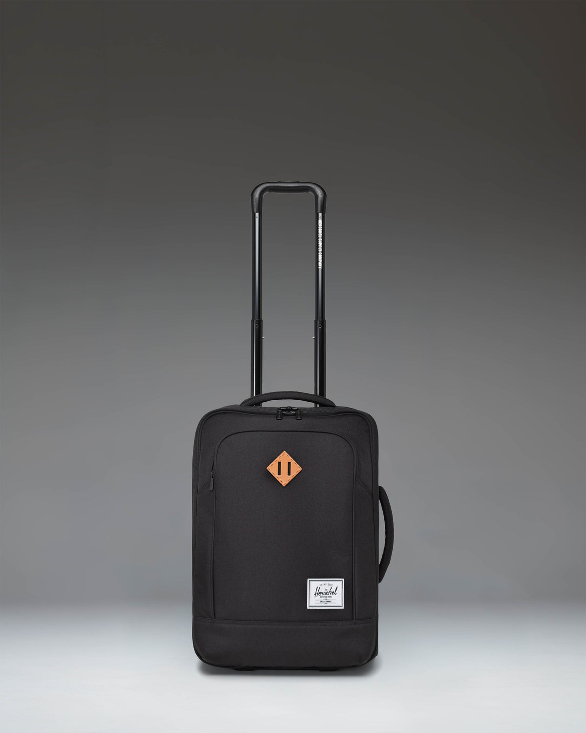 Herschel Heritage Softshell Large CarryOn Luggage in Black, showcasing a durable exterior, sleek wheels, and a sturdy telescoping handle.