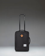 Herschel Heritage Softshell Large CarryOn Luggage in Black, showcasing a durable exterior, sleek wheels, and a sturdy telescoping handle.