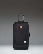 Herschel Heritage Softshell Medium Luggage in black, showing an oversized view of the front exterior fabric, zipper, and subtle tonal branding.
