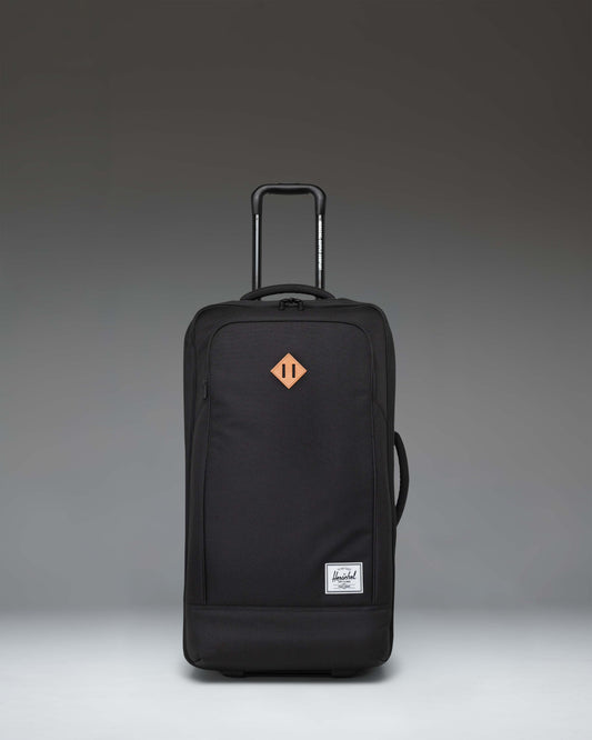 Herschel Heritage Softshell Medium Luggage in black, showing an oversized view of the front exterior fabric, zipper, and subtle tonal branding.