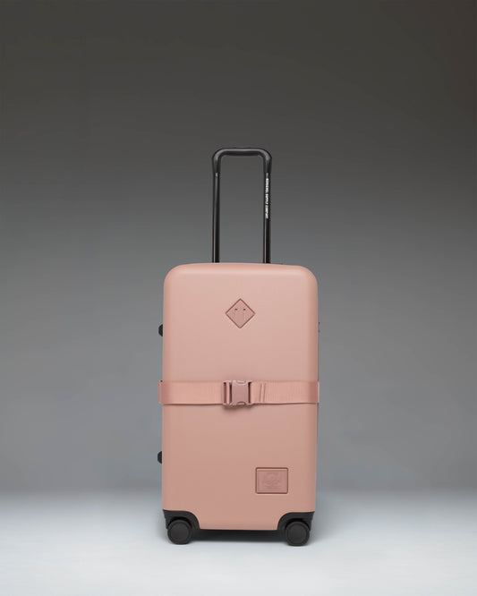 Herschel Heritage Hardshell Medium Luggage Exp in Ash Rose color, showing the front view of the hard-shell rolling suitcase.