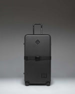 Herschel Heritage Hardshell Large Luggage Exp in Black, showing the front view of the durable rolling suitcase.