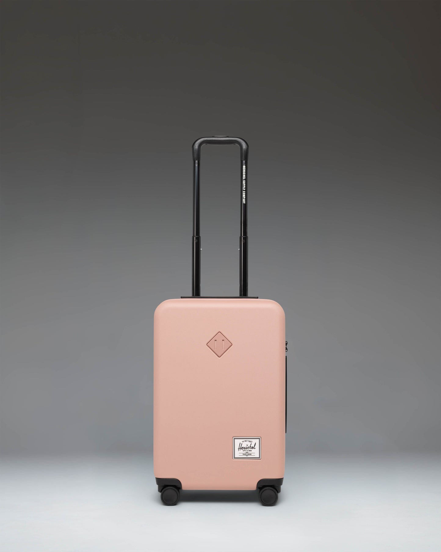Herschel Heritage Hardshell Large CarryOn Luggage in Ash Rose pink.