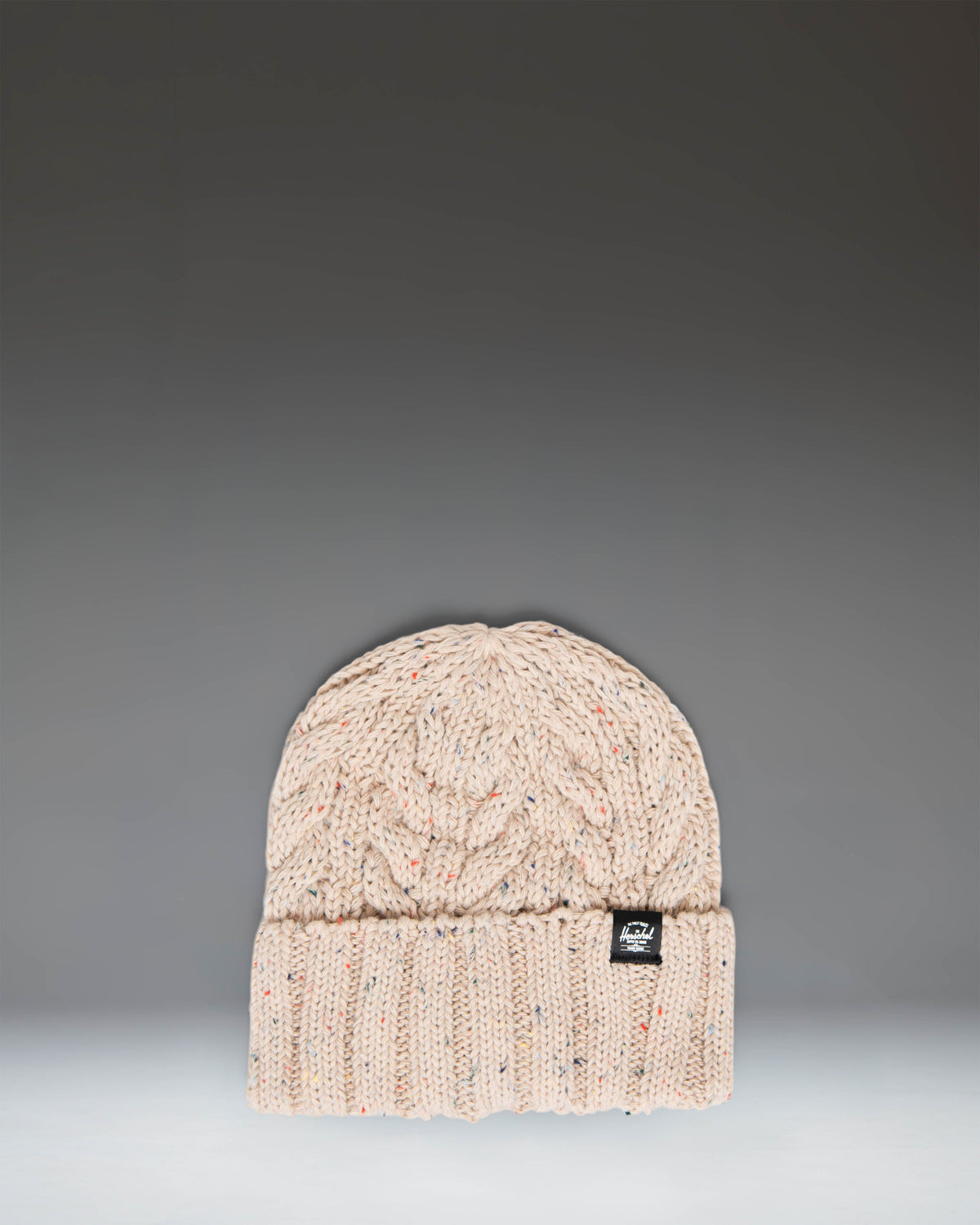 Herschel Supply Co. Ellis Cable Beanie in Vintage White Marled, featuring a classic cabled knit texture and a folded cuff.