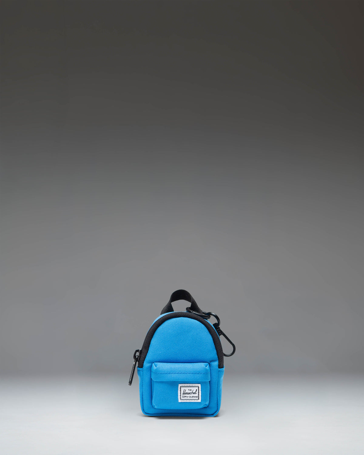 Herschel Classic Backpack Bag Charm in French Blue, showcasing its miniature design, zipper closure, and key ring attachment.