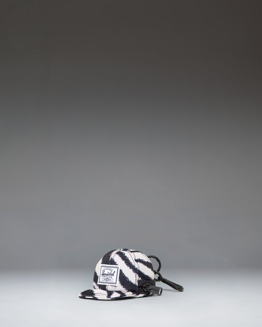 Herschel Supply Co. Sylas Classic Cap Bag Charm in black and white zebra print.