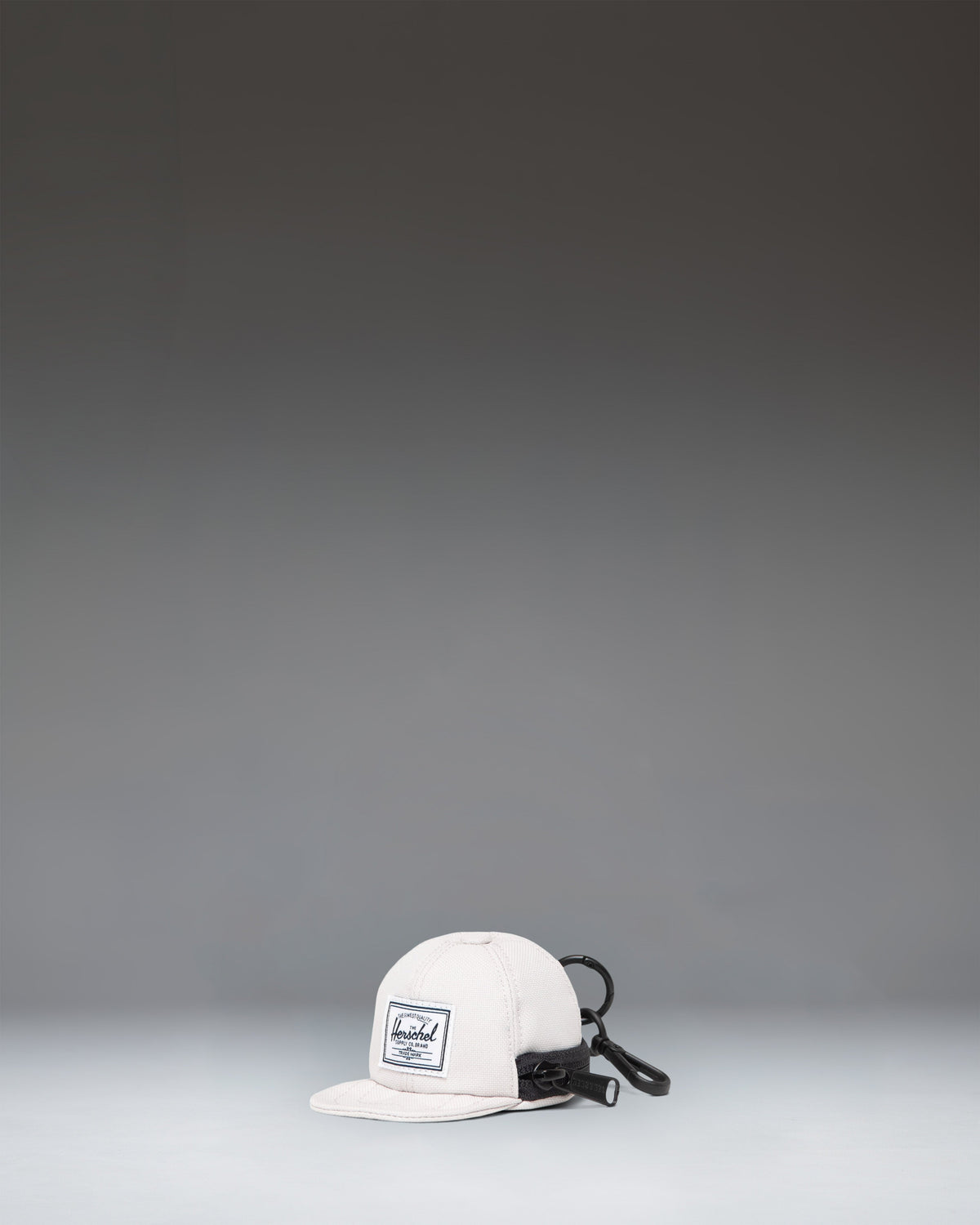 Herschel Supply Co. Sylas Classic Cap Bag Charm in the off-white Moonbeam colorway.
