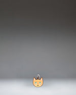 Herschel Cat Bag Charm in Orange Cat colorway, featuring a stylized orange cat design.