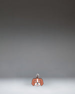 Herschel Dog Bag Charm in Brown Dog, a small plush dog accessory designed as a stylish bag charm.